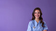 A woman in a blue scrubs is smiling and posing for a picture. She is a doctor and is wearing a stethoscope around her neck