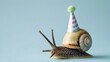 Whimsical Snail Wearing a Colorful Party Hat on a Pale Blue Background