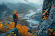 A climber who has reached the top looks at the majestic autumn landscape