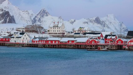 Wall Mural - Stunning winter sunset on popular tourist destination - Sakrisoya port with huge snowy peaks on background, Norway, Europe. Fantastastic landscape of Lofoten Islands. Full HD video (High Definition).