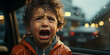 Portrait of a boy in the rain. The boy screams in fear.