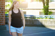 Young blonde woman wears a black tank top with copy space or text space for print or design	

