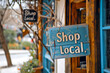 © VicenSanh - A storefront with a sign saying 'Shop Local,' promoting community support