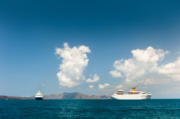 Wall Mural - Santorini island, Greece. Cruise ship near the coast. Blue sea and the blue sky.