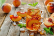 sparkling peach iced tea in a mason jar with fresh  slices