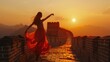Chinese girl dancing On the Great Wall of China, the golden sky in the evening 