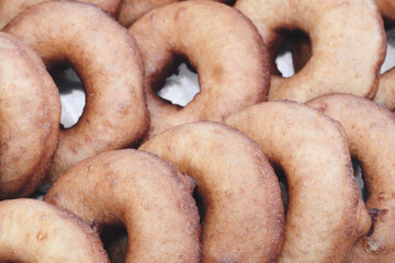 Poster - A stack of donuts with a brown glaze. The donuts are piled on top of each other, creating a visually appealing and appetizing display
