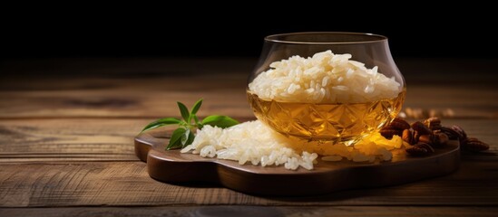 Poster - A glass of rice and a spoon on a wooden table