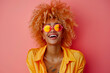 Joyful African American woman with blonde afro hair in colorful glasses laughing and having fun