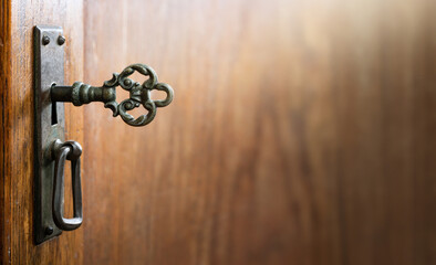 Fototapete - Old key in keyhole, macro shot. Gothic style. Key to knowledge. Concept and Idea for History, education, security, imprisonment, dungeon, prison background. Space for design.