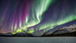 Aurora borealis above the snow covered mountain range. Northern lights in winter. Night landscape with polar lights and snowy mountains. Starry sky with aurora over the rocks. Generative Ai content.