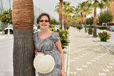 Fototapeta Kwiaty - Szczęśliwy senior na wakacjach, dojrzała kobieta na emeryturze, seniorka relaksuje się na urlopie, starsza kobieta podróżuje, Hiszpania, Costa del Sol.