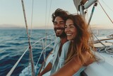 Fototapeta Tulipany - Couple joyfully sailing small yacht amidst the sea waves
