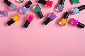 Pattern background of bottles colorful nail polish, top view, copy space