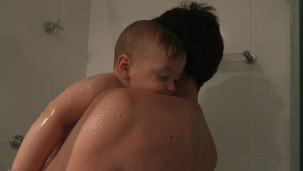 Wall Mural - Father showering baby son bonding