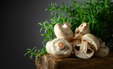 Poster - White champignons with rosemary on a wooden board.