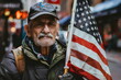 old man hold national flag of United States on city street