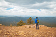 © Pritha_EasyArts - Solo traveler in the mountains. Man with a backpack enjoying the mountains view. Payson, Arizona