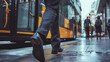 Pedestrian walking by a bus on a rainy city street