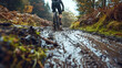 A cyclist tackling a steep muddy incline on a mountain bike.