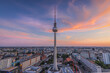 Sunset over the roofs of Berlin. Skyline with television tower in the evening in the center of the capital of Germany. Tallest building on Alexanderplatz with the Red Town Hall under a cloudy sky