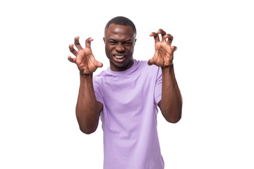 Wall Mural - close-up portrait of a young happy american man in a lilac t-shirt grimacing