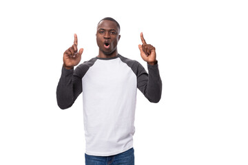 Wall Mural - a young American guy with a short haircut, dressed in a long-sleeve sweater, tells the news with surprise