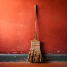 Wooden Broom Resting Against Brightly Painted Wall – A Glimpse Into Traditional Cleaning Methods