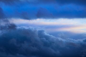 Sticker - Blue clouds in the sky and a strip of light on the horizon, sky with blue clouds and sunlight in the distance