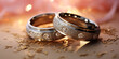 Two wedding rings placed on a wooden table surface.