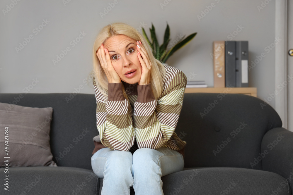 Shocked mature woman video chatting at home