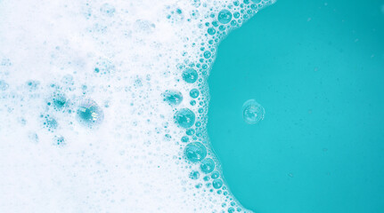 Wall Mural - Detergent foam bubble on water. Blue background, Soap sud