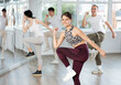 © JackF - During dance workshop, girl with team of young like-minded people learn to dance modern dances. Studio school for amateur and professional dancers