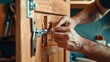 Craftsman installing a metal hinge on a wooden cabinet. Close-up of handwork and cabinetry. Concept of carpentry, manual work, precision, and home improvement.