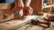 Skilled hands fastening a hinge to a wooden cabinet. Precision and craftsmanship in cabinetry. Concept of woodworking, fine joinery, furniture construction, and handwork.