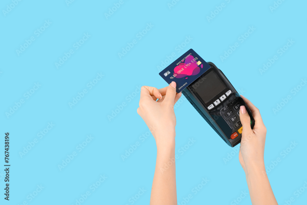 Woman with credit card and payment terminal on blue background