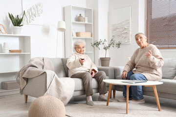 Poster - Senior female friends watching TV at home