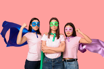 Sticker - Women in superhero costumes on pink background. Women's history month