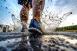 Perspective view from behind a runner sport shoes on a puddle with water splash