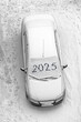 snow-covered car with the inscription 2025