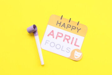 Wall Mural - Festive postcard for April Fools Day with party whistle on yellow background