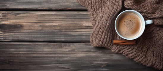 Canvas Print - A wooden table with a cup of coffee and a scarf, showcasing the beautiful hardwood plank flooring with tints and shades enhanced by varnish