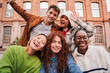 © Jose Calsina - Close up portrait of a group of friends having fun and smiling together. High school students looking at camera with happy expression. Young friendly real people staring front posing for a photo