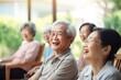 © Наталья некрасова - A small group of elderly Asians gather together, talking and laughing, sitting at a table in nature. Time spent with friends.