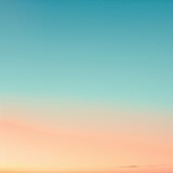 Fototapeta Zachód słońca - A minimalist background with a gradient from soft peach to a tranquil sky blue evoking a serene dawn