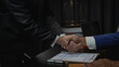 Law and justice concept, businessman shaking hands with lawyer to seal agreement with lawyer, partner or lawyer discussing contract agreement The concept of holding hands. Close-up.