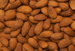 Close up peeled almonds nuts background top view using for your advertising