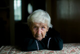 Fototapeta  - Portrait of an elderly woman in reflection.