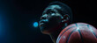 Dynamic african-american basketball player in action with flashlights