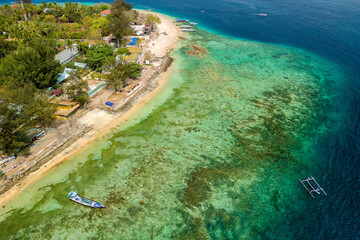 Wall Mural - Aerial view of tourist boats over the coral reef flat on a small tropical island